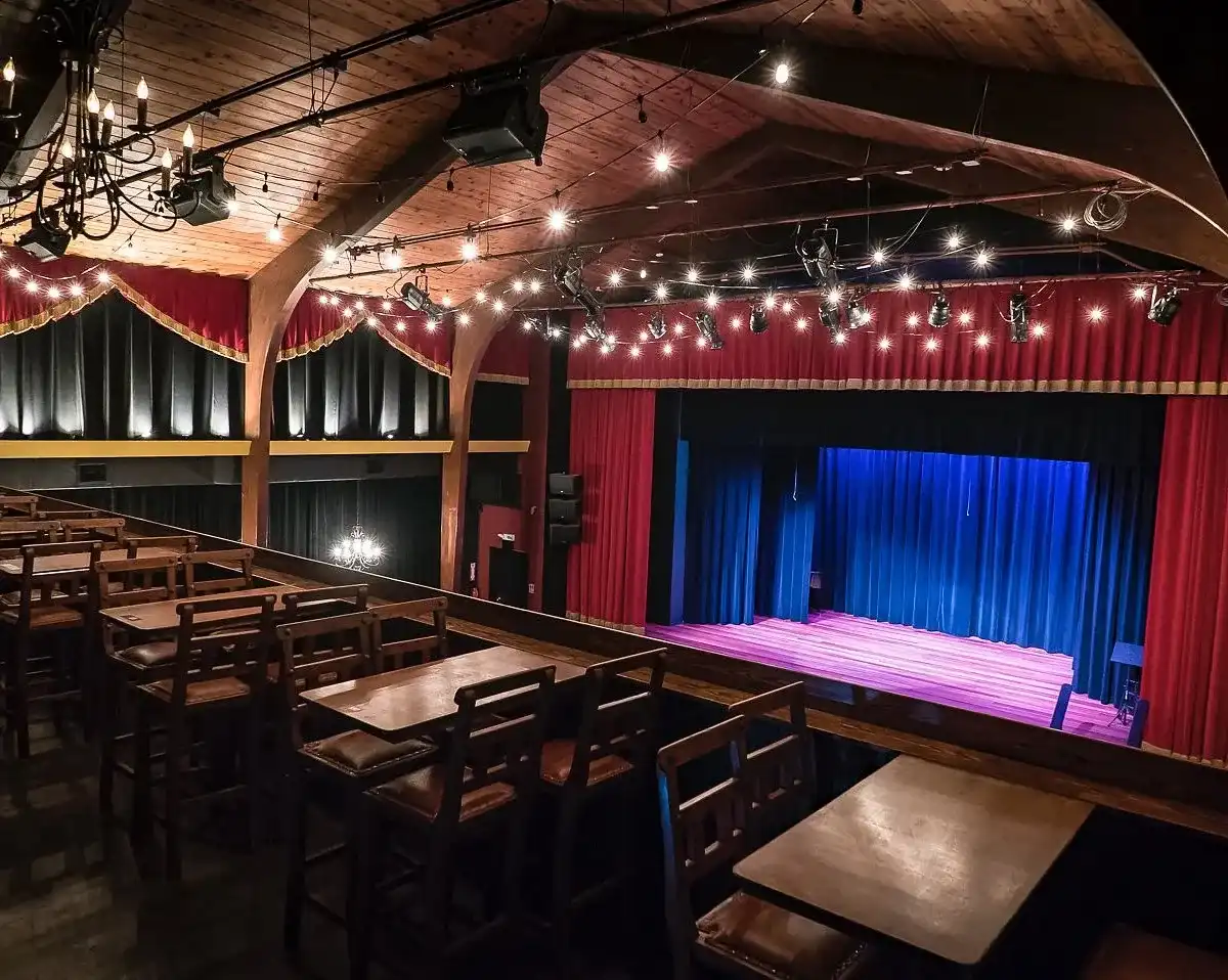 Key West Theater balcony seating with stage and red curtains